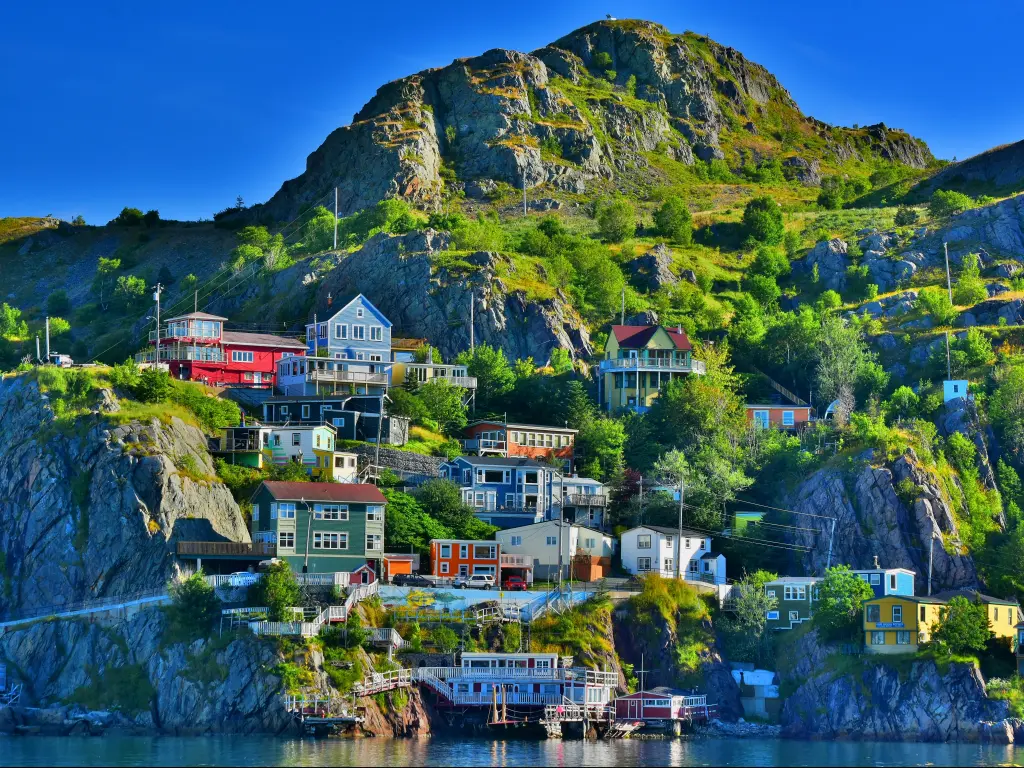 Colorful buildings perched on the rocky cliffs at The Battery, St John's, Newfoundland, at sunrise.