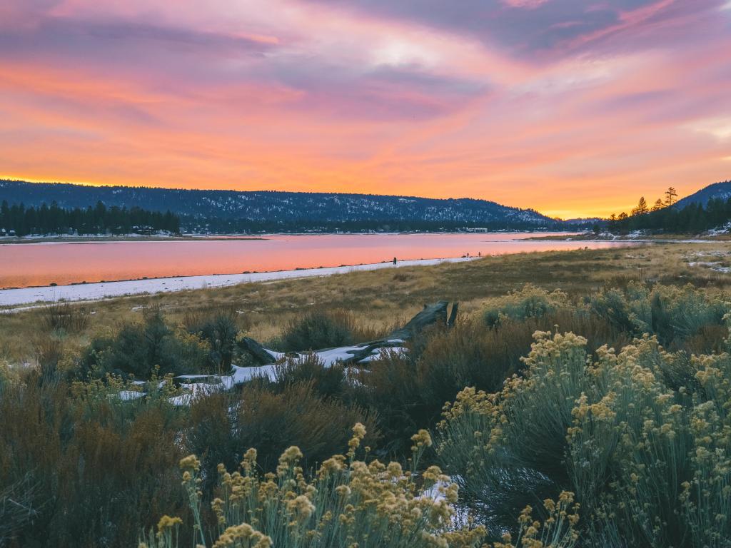 Big Bear Lake, California, USA at sunset with snow on the foreground. 