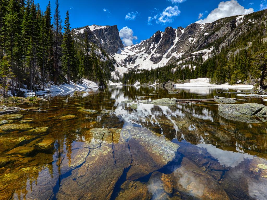 Crystal-clear Dream Lake with snowy mountains in the background