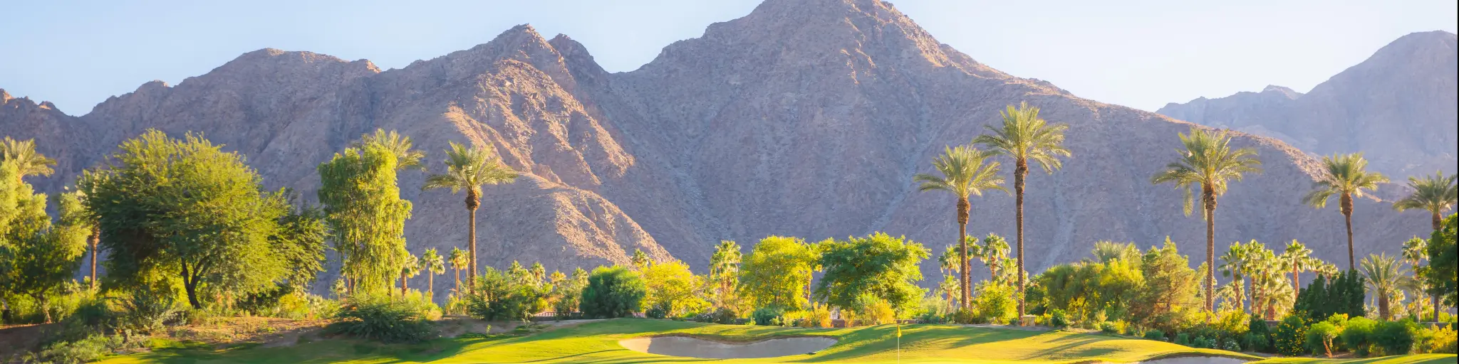 Palm Springs, California, USA with a beautiful golden light over Indian Wells Golf Resort, a desert golf course in Palm Springs, California, USA with view of the San Bernardino Mountains.