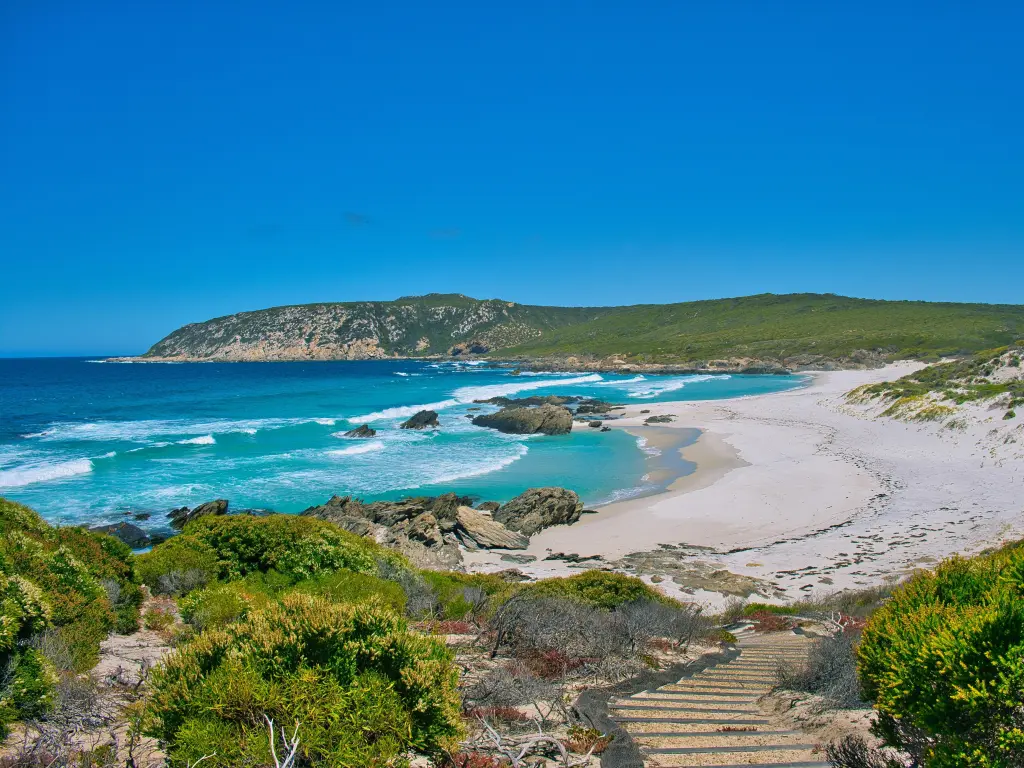 Beautiful bay with white sand and turquoise waters, waves coming in