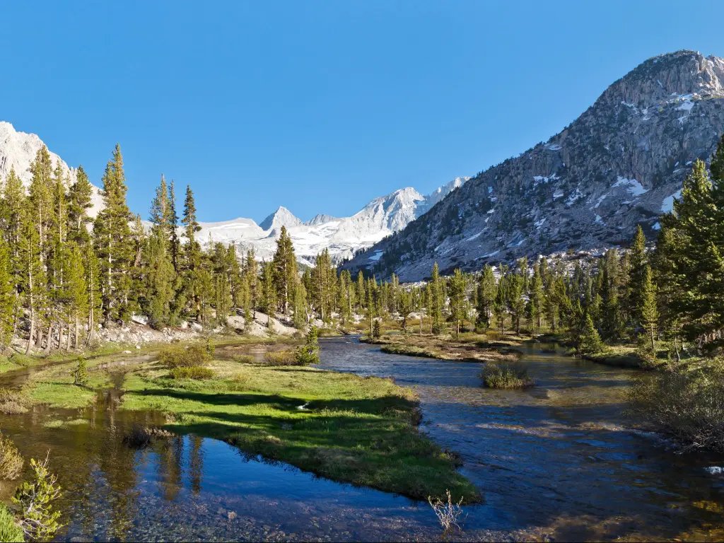 Bubbs Creek in Kings Canyon National Park with Forester Pass in the Distance and a blue sky above and snow capped mountains