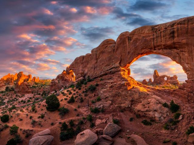 Arches National Park, Utah in evening light over North Window with Turret Arch in the distance. 