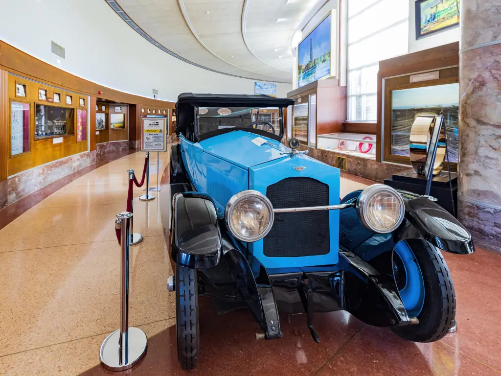 Interior of the museum with a vintage blue car in focus