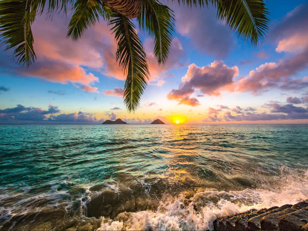 Sunrise casting purple light on the clouds over Lanikai Beach in Kailua, Hawaii