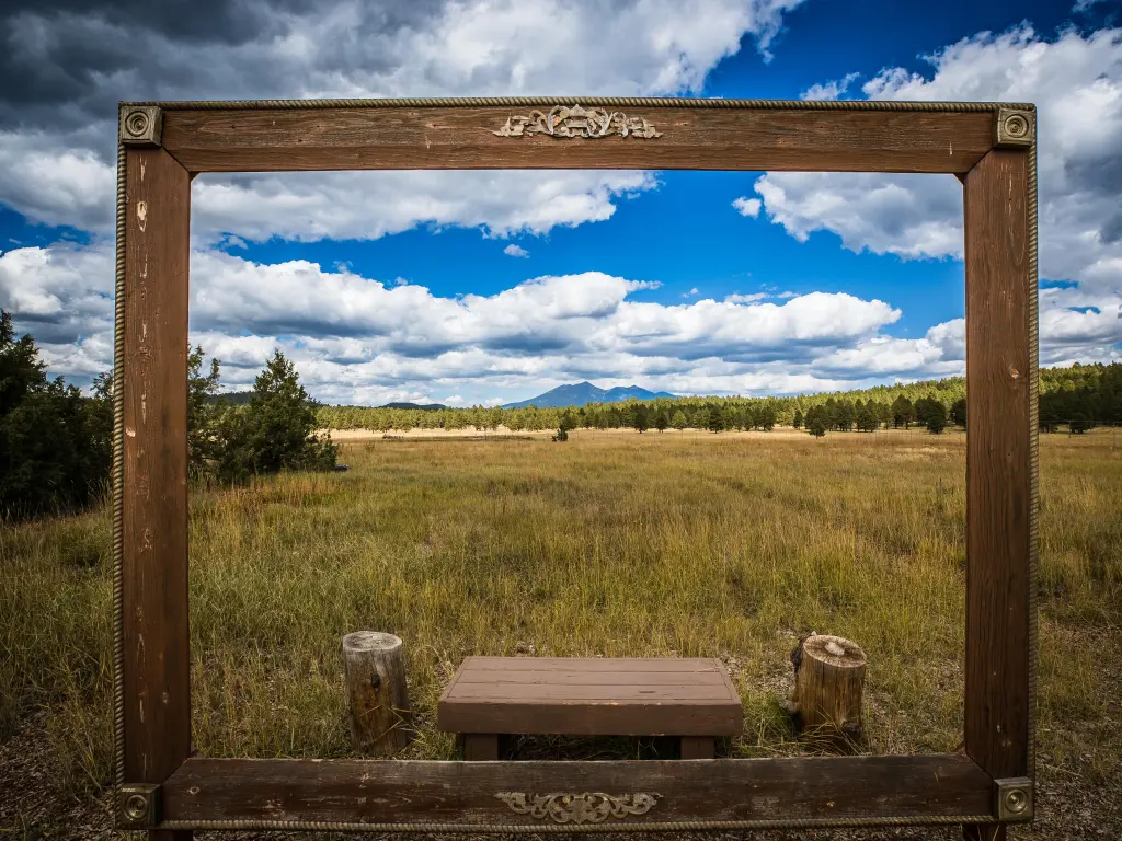 Wooden frame for a photo op in the arboretum with The San Francisco Peaks rising in the background