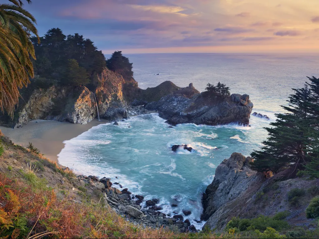 Small cove with sandy beach and rocky cliffs